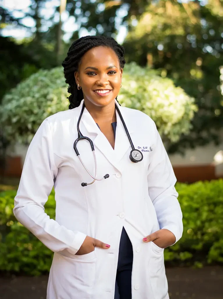 Dr. Wangui Waithaka in a white coat with a stethoscope, representing her commitment to continuous medical education and patient excellence in 2025