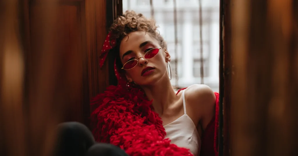 Elegant woman reflecting in a minimalist room, symbolising a powerful mommy makeover story of self-rediscovery